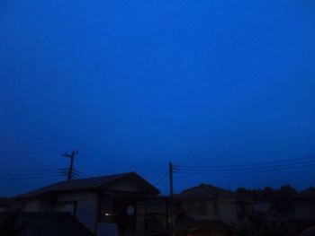 Low angle view of houses against blue sky