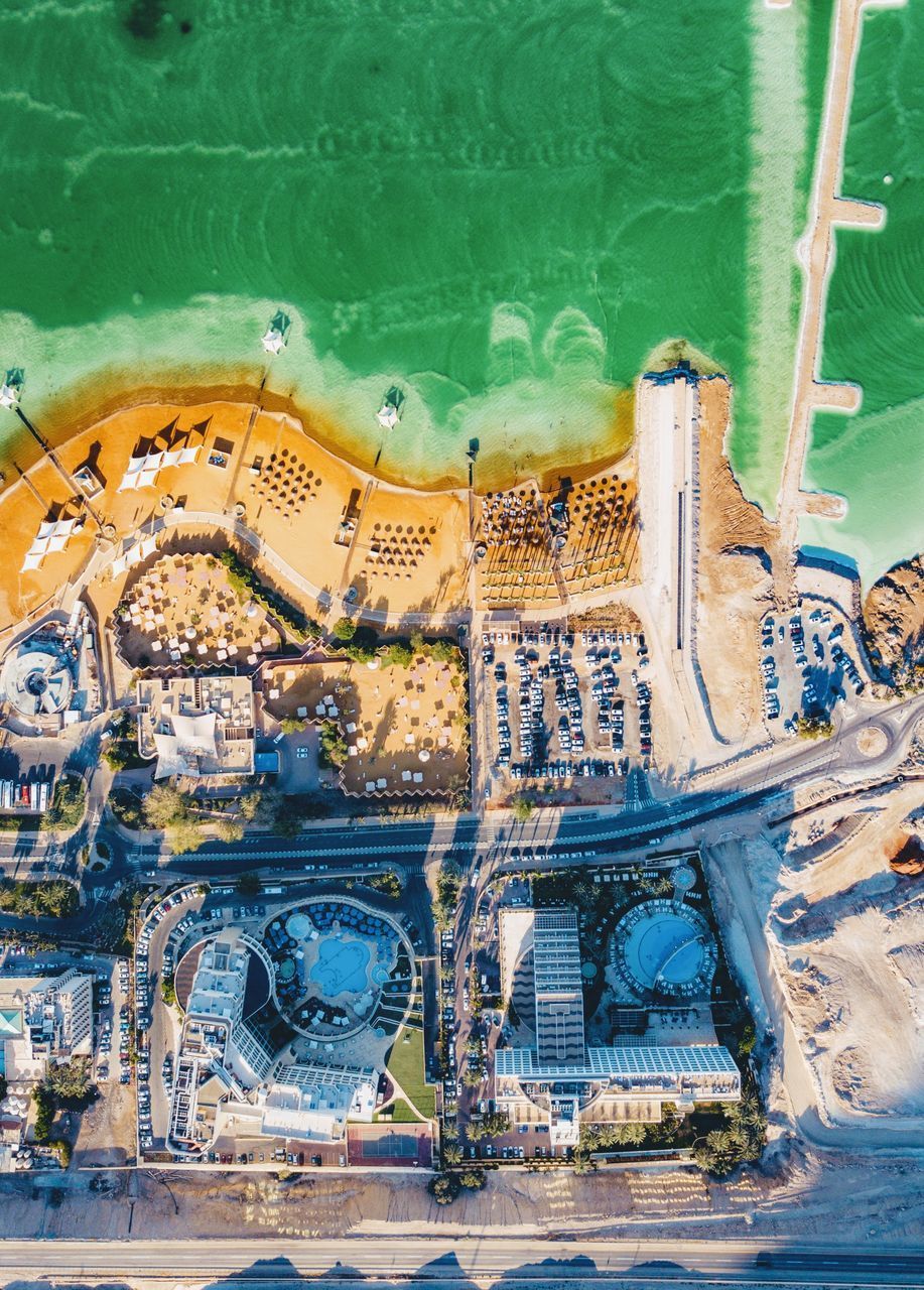 HIGH ANGLE VIEW OF SWIMMING POOL AGAINST BUILDING