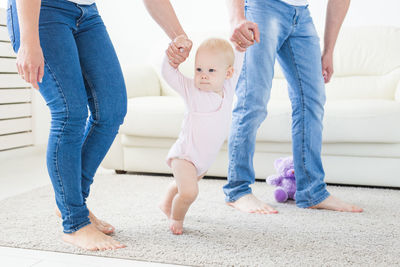 Parents playing with daughter at home