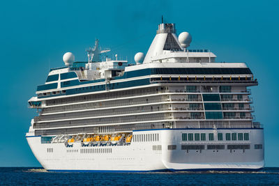 View of ship in sea against clear blue sky