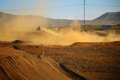 Motorcycle racing on dirt road