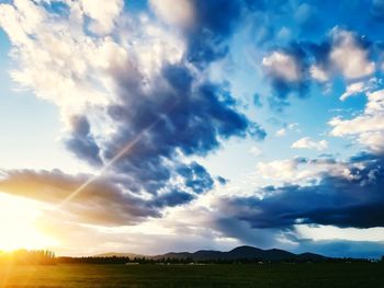 Scenic view of field against sky during sunset