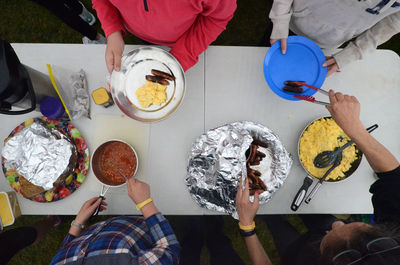 High angle view of people serving food at table