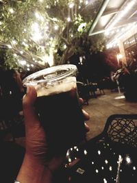 Close-up of hand holding beer glass