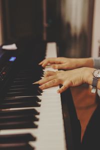 Midsection of woman playing piano