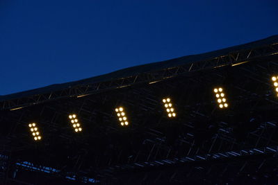 Low angle view of illuminated building against clear sky at night