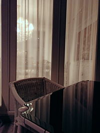 Empty chairs and table against window at home
