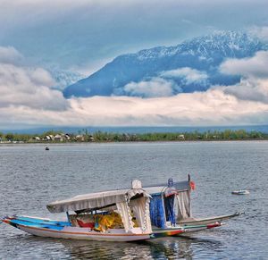 Boats in lake against sky