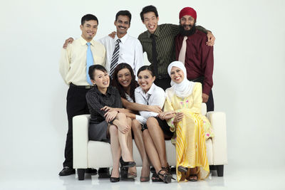 Portrait of smiling colleagues against white background