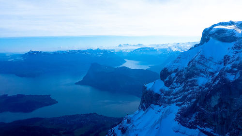 Scenic view of snowcapped mountains against sky