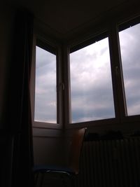Low angle view of sky seen through window of house