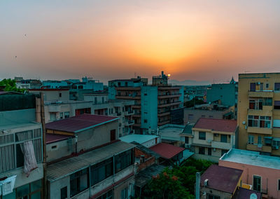 High angle view of buildings against sky during sunset