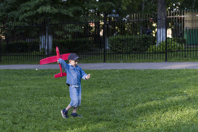 Full length of boy playing on field