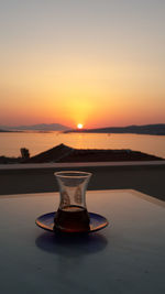 Water on table against sky during sunset