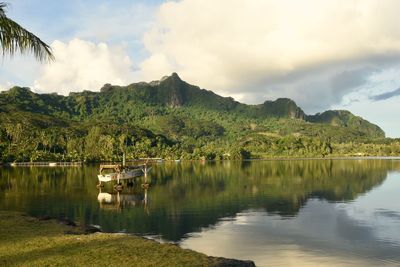 Scenic view of lake and mountains against sky