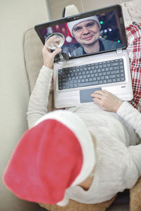 Safe online celebration. senior woman holding a glass of wine and celebrating christmas virtually 