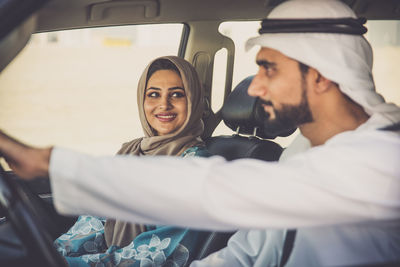 Smiling couple sitting in car