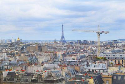 Buildings against cloudy sky