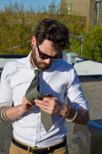 Close-up of man wearing necktie while standing outdoors