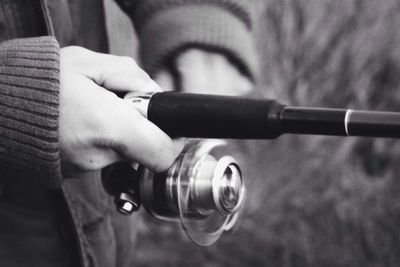 Cropped image of man holding camera