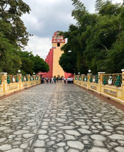 People walking on footpath in city