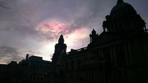 Low angle view of buildings against sky at sunset