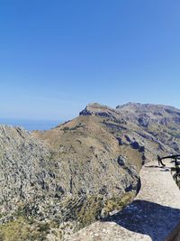 Scenic view of mountains against clear blue sky