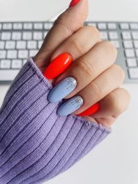 Cropped hand of woman using laptop