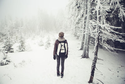 Portrait of smiling standing on snow covered landscape