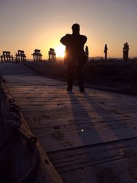 Silhouette of woman at sunset