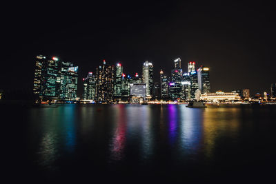 Illuminated city at waterfront