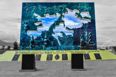 Digital composite image of sign board against sky