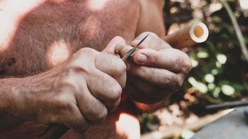 Close-up of man holding cigarette