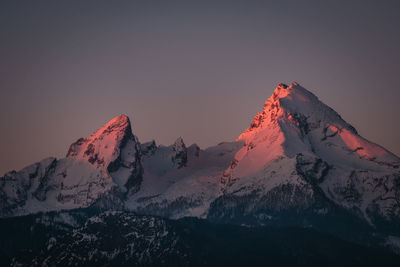 Snow covered mountain against sky during sunset