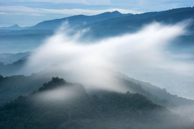 Sunrise over the mountain range, beauty rainforest landscape with fog in morning.
