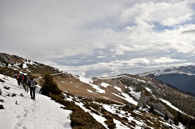 Scenic view of snow covered mountains against sky