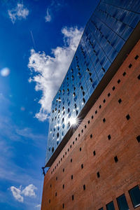 Low angle view of modern building against blue sky