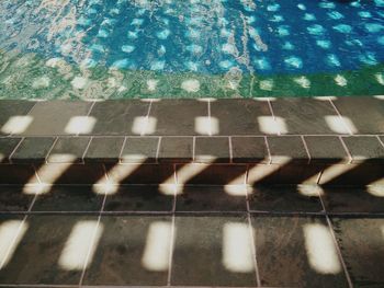 High angle view of sunlight falling on poolside