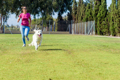 Full length of a dog running on grassland