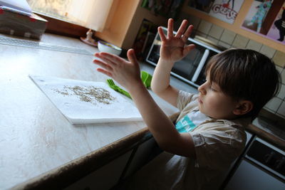 High angle view of cute boy on table