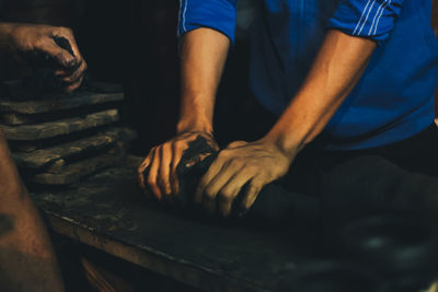 Midsection of man working at workshop