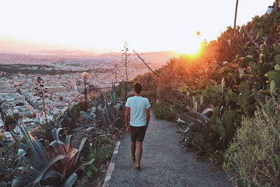 Man walking down mount lycabettus during sunset in athens, greece.