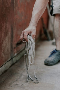 Caucasian male builder holds an old silicone window in his hand.