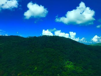 Scenic view of landscape against blue sky