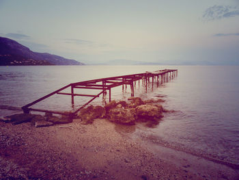 Scenic view of calm lake against mountain range