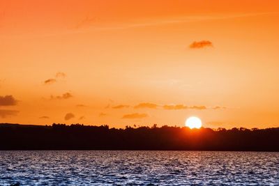 Scenic view of sea against orange sky