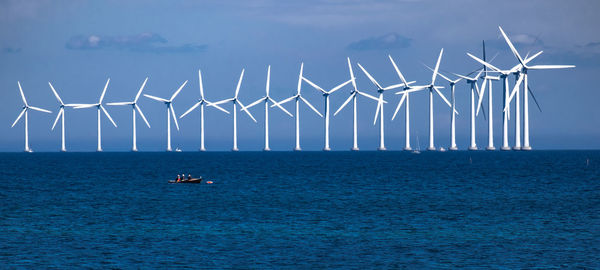 Sailboats in sea against sky