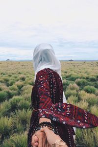 Woman on field against sea