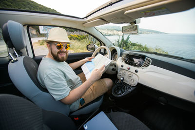 Portrait of smiling woman sitting in car