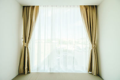 Curtains hanging by window at home